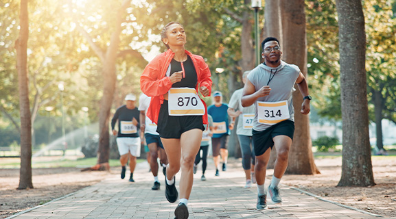 Participants running in a park during a community wellness event.
